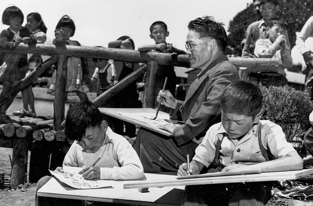 Asian American children writing.