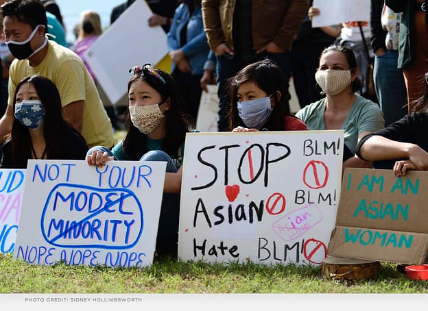An image from the cover of "The Deciding Margin" report, with protestors who are holding signs reading "Not Your Model Minority" and "Stop Asian Hate"